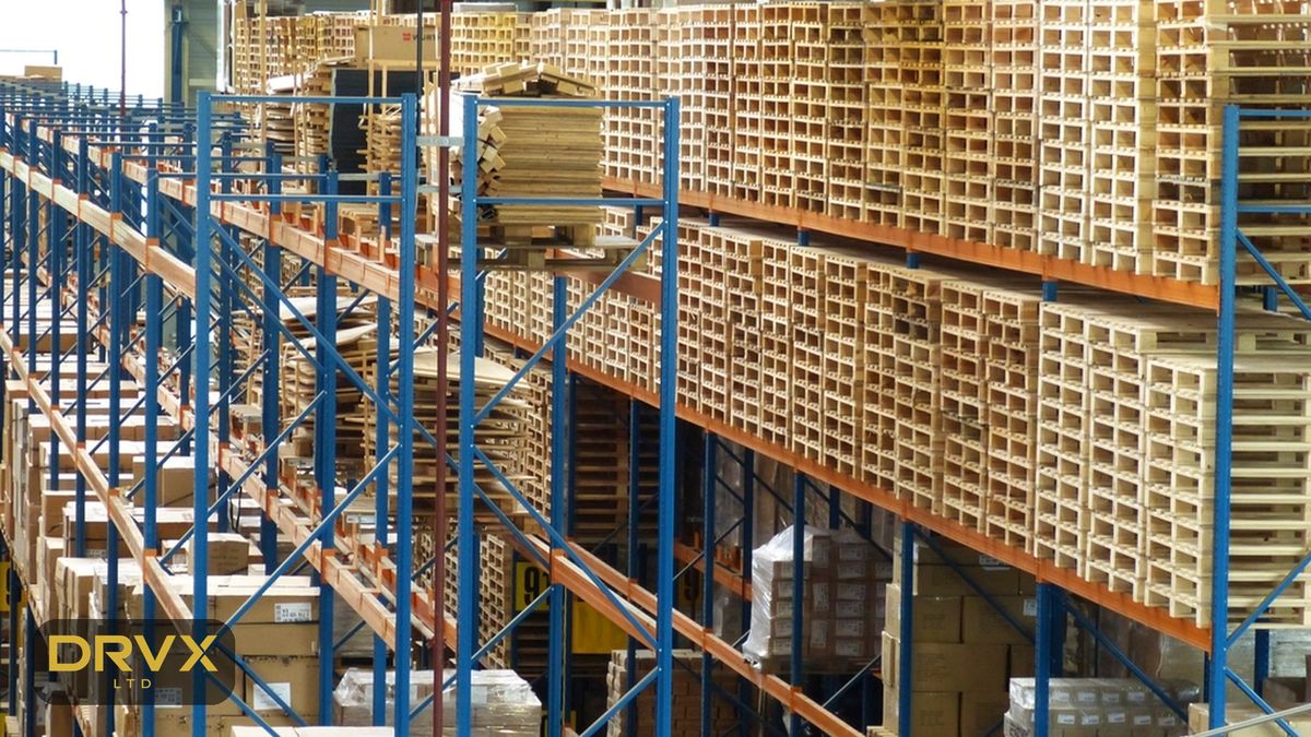 Illustrative image: wooden pallets stored in high warehouse racking, with a gold DRVX mark
